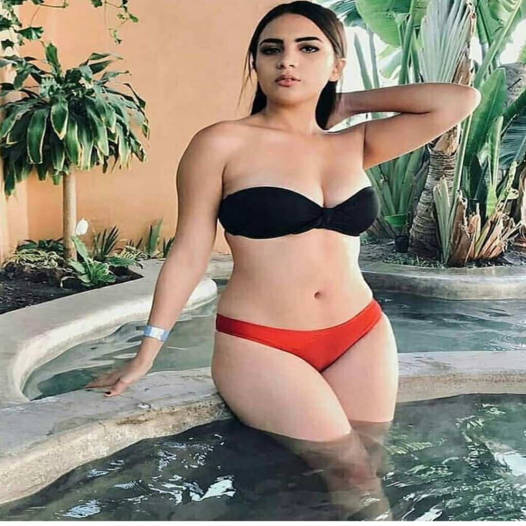 A HOT GIRL 24 YEARS OLD NAME IS URBASI IN RED AND BLACK BIKINI STANDING POSE IN THE SWIMMING POOL